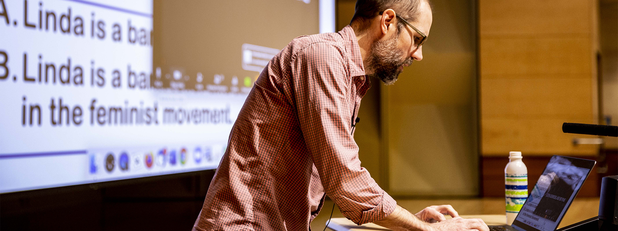 A faculty member standing at the front of a room teaching a course in the UW Department of Philosophy.