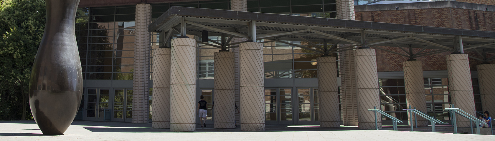 Physics and Astronomy building outside plaza with columns and an art piece.