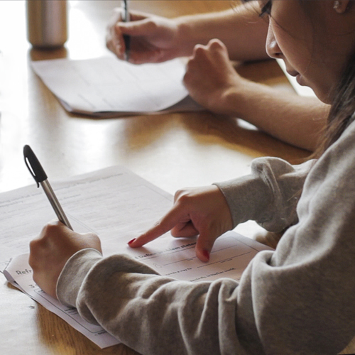 Student filling out a form.