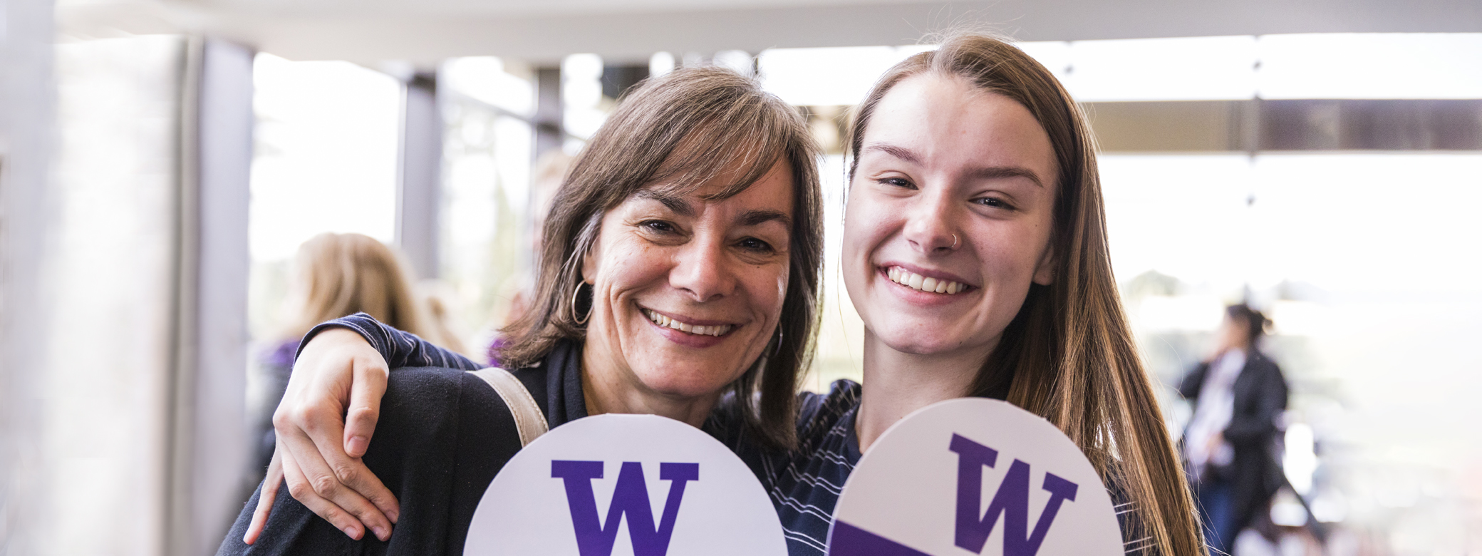 Parent and child holding "W" signs