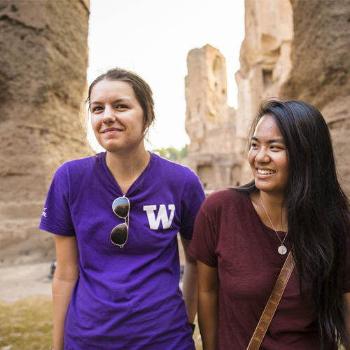 Students on study abroad, with craggy rocks rising behind them. 