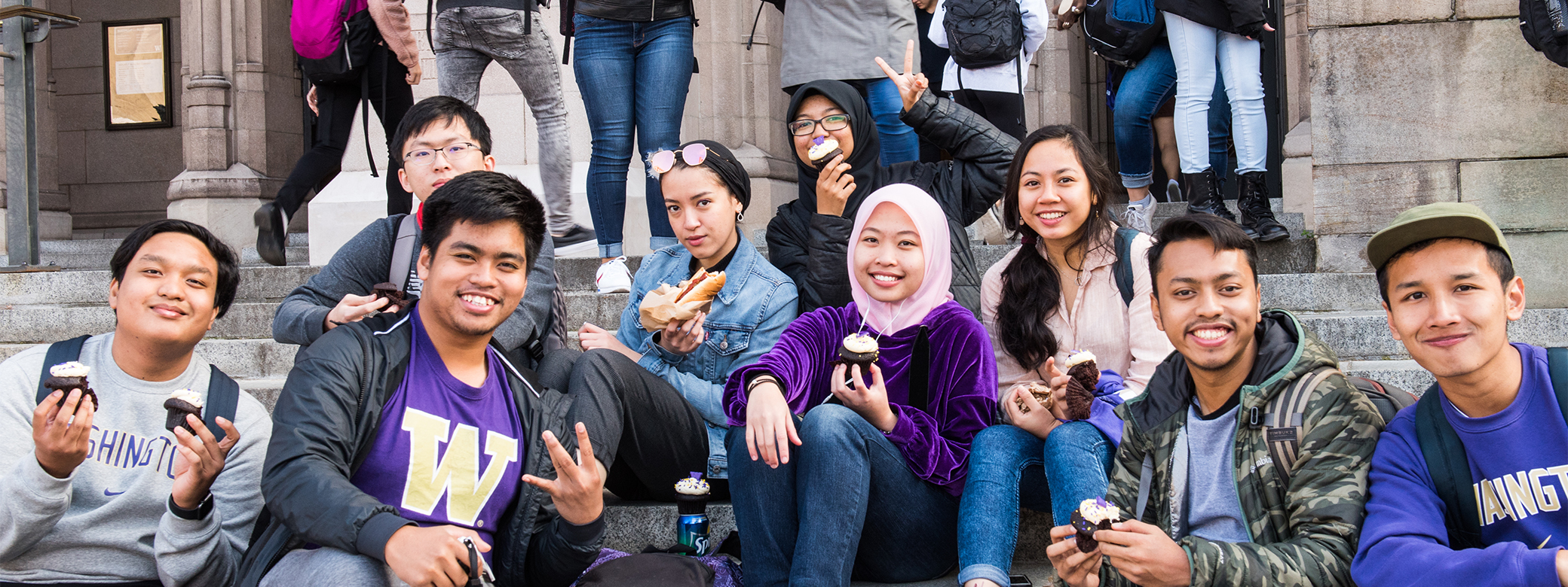 Group of students seated on the steps outside Suzzallo Library.