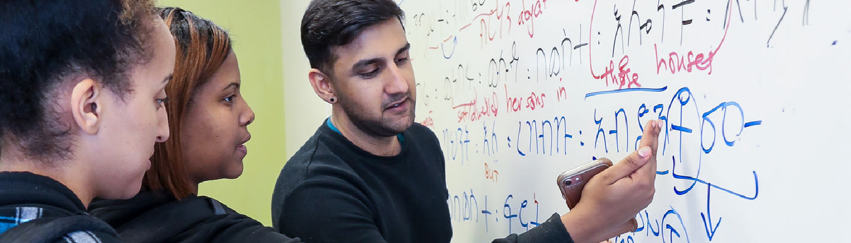 People looking at text on a whiteboard