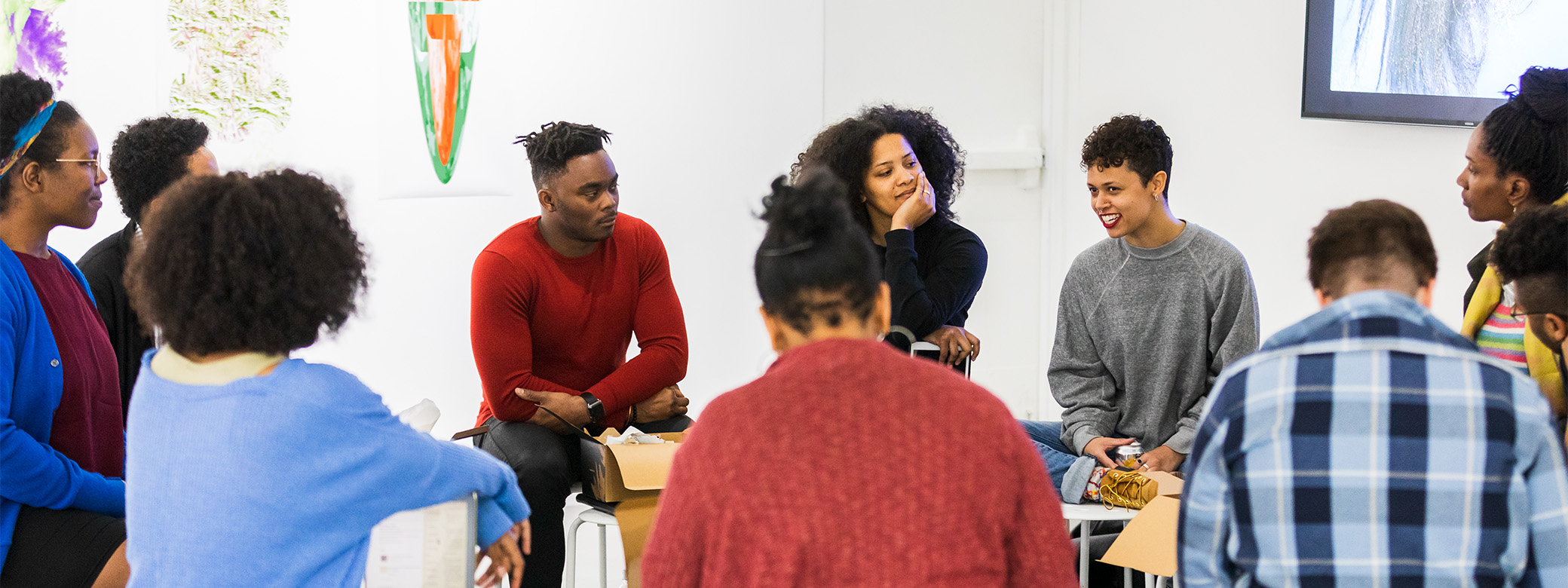 Group of students sitting in a circle in a gallery 