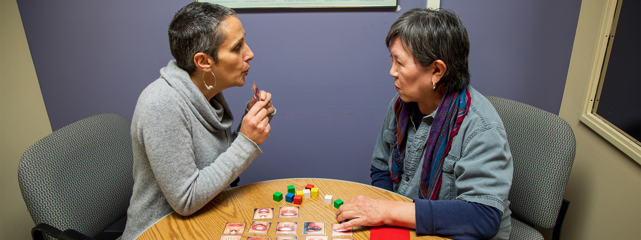 Woman helping other woman with speech practices