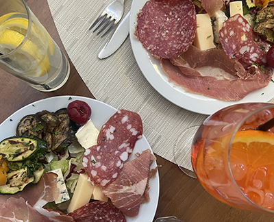 Plates of cheese and prosciutto 