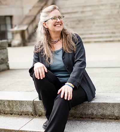 Professor Laada Bilaniuk on the steps outside UW's Denny Hall.