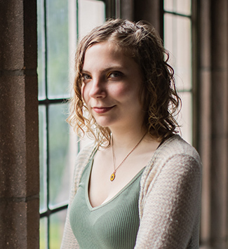 Darby Sherwood stands by a window in UW's Hutchinson Hall. 