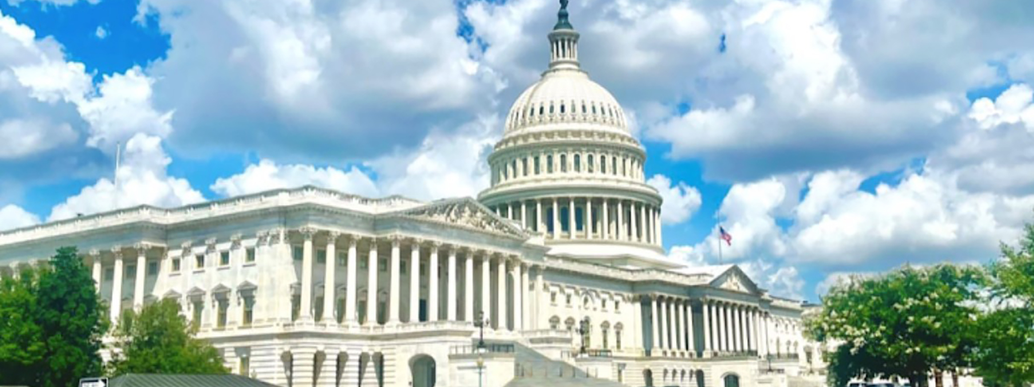 The Capitol building in Washington, DC, with blue skies and clouds