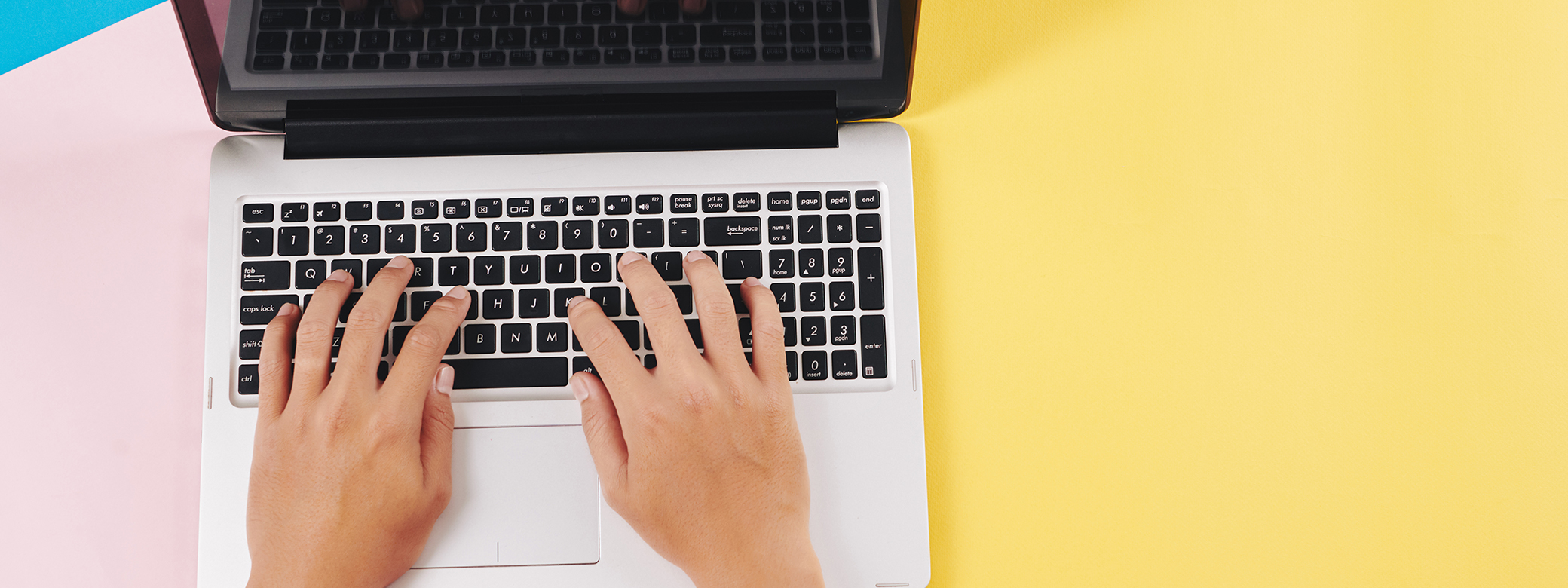 hands typing on a laptop