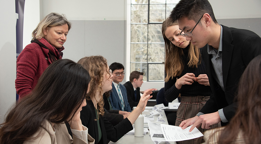 Meng and other students prepare for Task Force presentation as Professor Sabine Lang looks on.