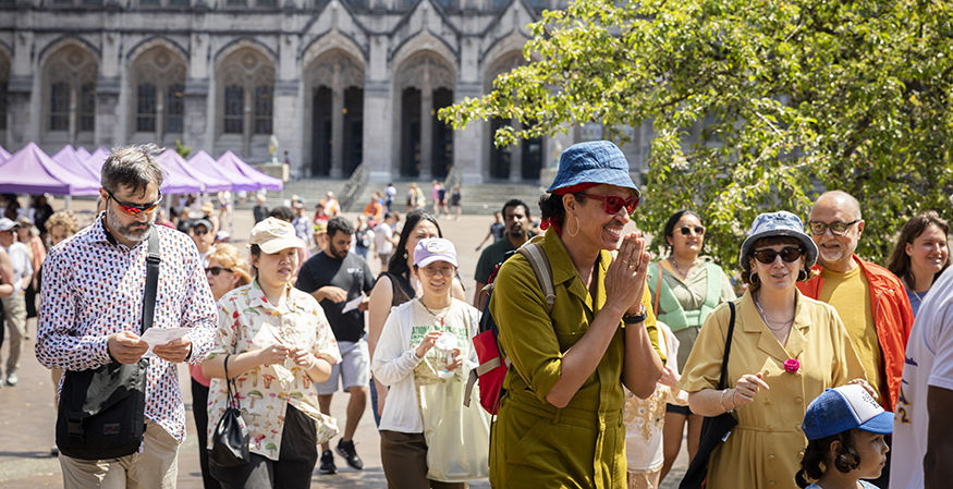 Daniel Alexander Jones and artist Afroditi Psarra chat while walking across UW's Red Square with others.