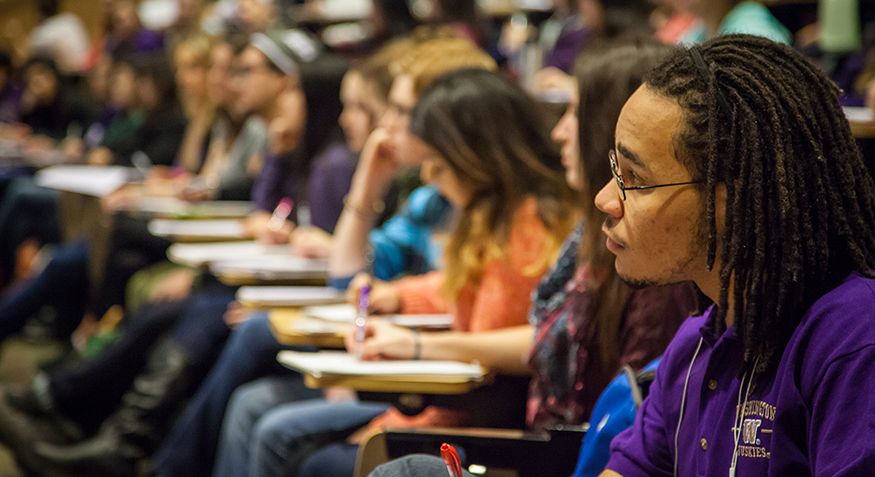 Students listening in a lecture classroom. 