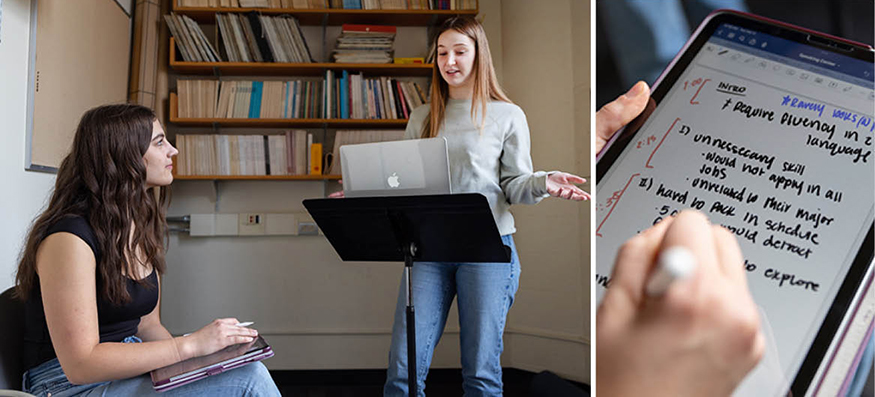 Seated student consultant takes notes on an iPad while a standing student practices their speech. 