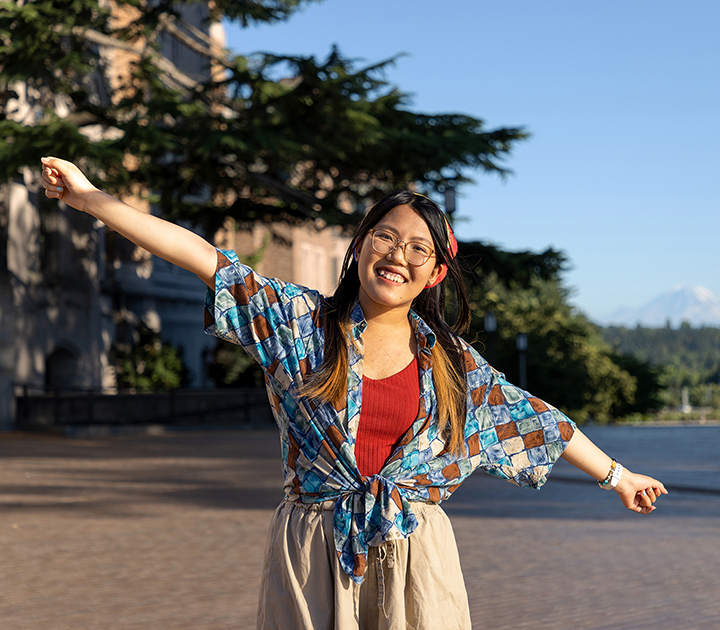 Simona Liao on UW campus, with arms outstretched