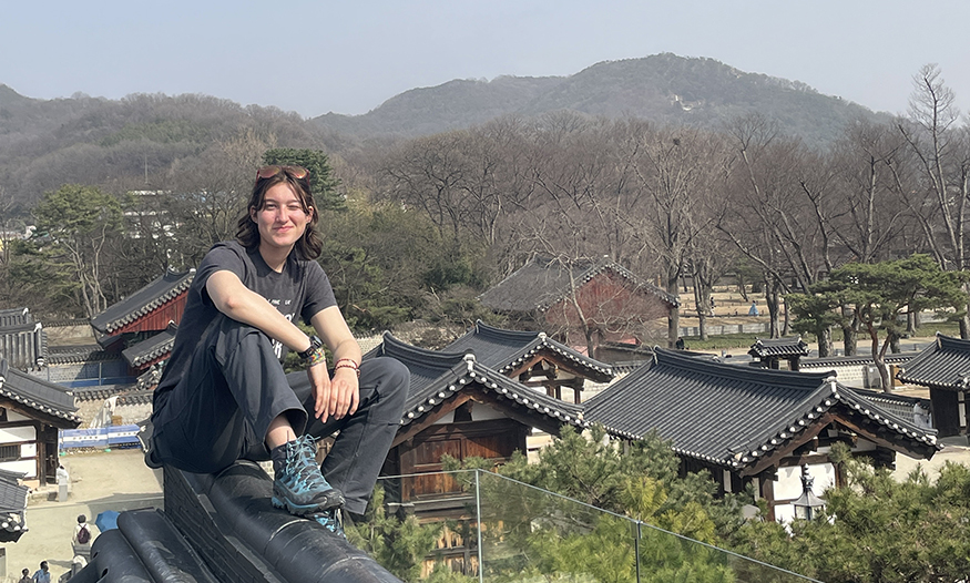 Katie Ruesink sitting on a rooftop in Korea.