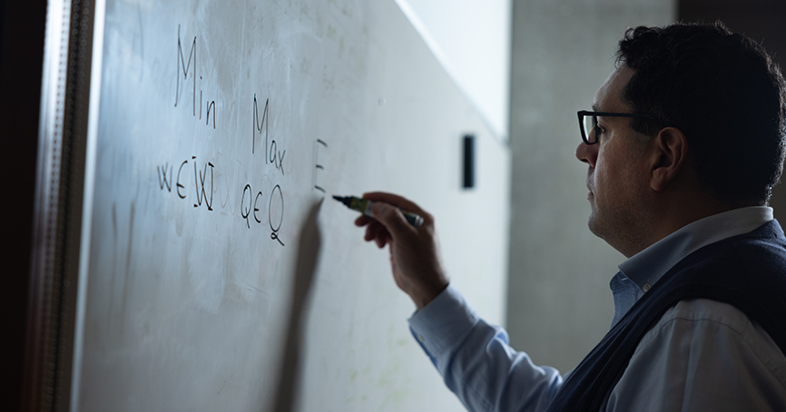 Zaid Harchaoui writing on a whiteboard.