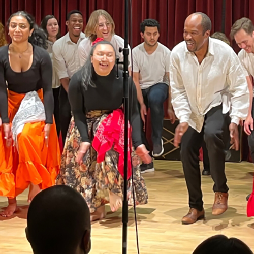 People dancing on stage in colorful clothes